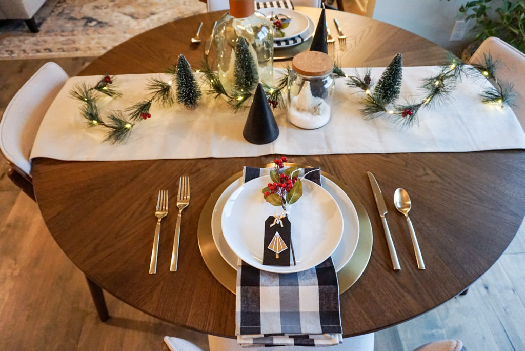 christmas tablescape with table runner, place setting, charger and centerpiece